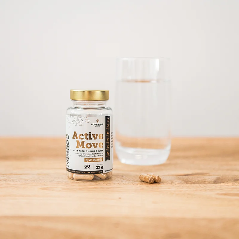 Active Move bottle on a wooden table next to a glass of water and two capsules